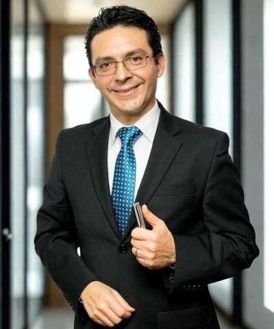 Consultor experto en servicios legales y servicios jurídicos posando en oficina para brindar asesoría personalizada.